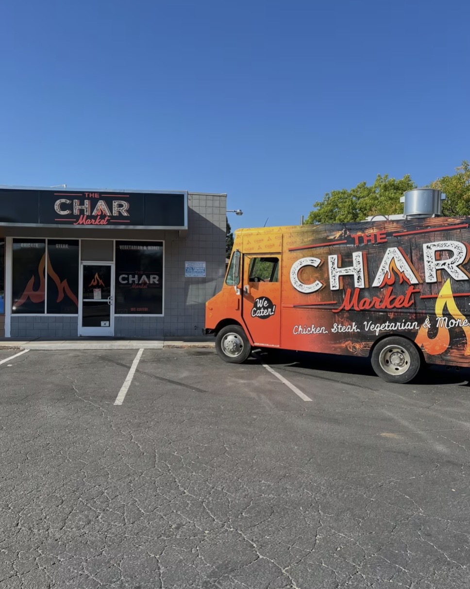 The Char Market orange truck by the storefront